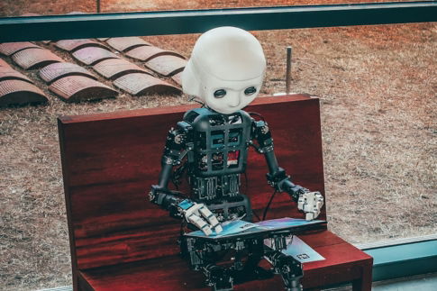 black and white robot toy on red wooden table